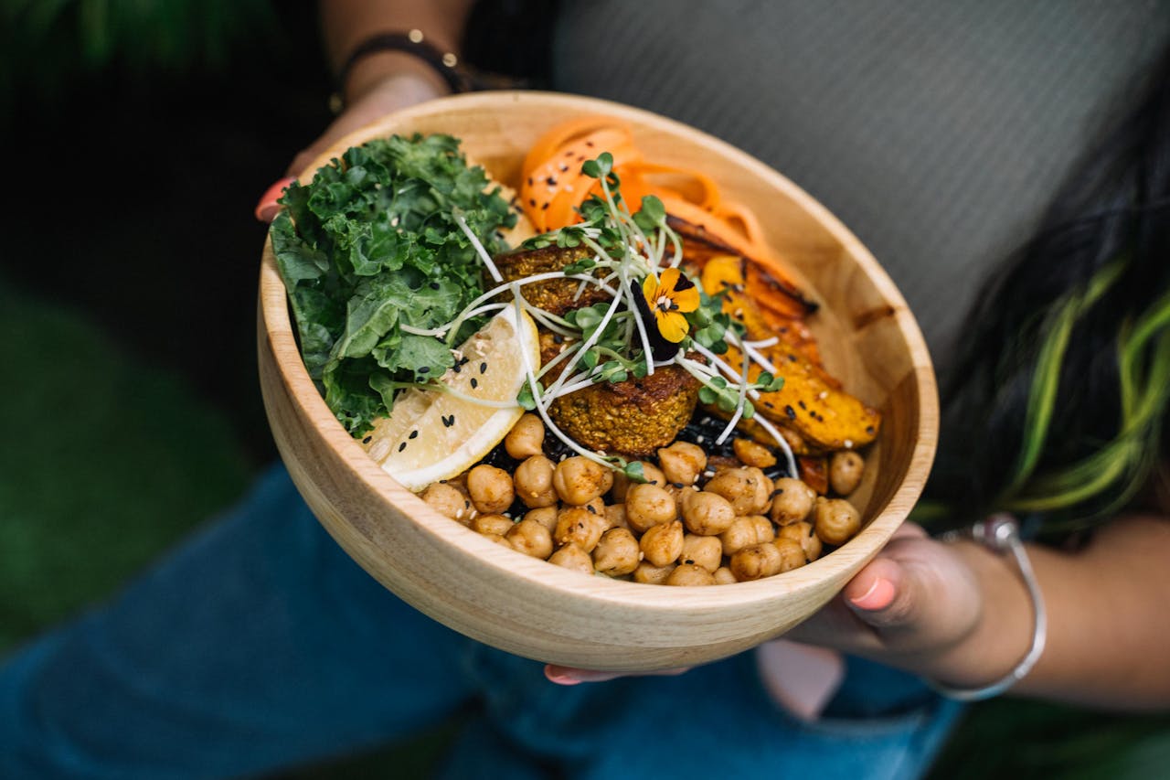services-03 Healthy vegan bowl with chickpeas, kale, carrots, and lemon served fresh.